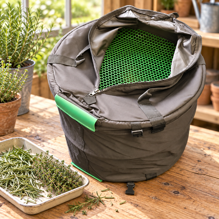Illustrative lifestyle image of the Trim-Barrell Dry Herb Shaker Unit on a timber workbench beside culinary rosemary and thyme.